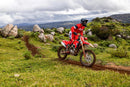 The 2025 Honda CRF450RX off-road motorcycle, featuring a black seat and knobby tires, is displayed in side profile. It highlights a lightweight frame, visible suspension components, and the Honda logo prominently on the side. The bike is equipped with Honda Selectable Torque Control for optimal performance across diverse terrains.