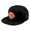 The Troy Lee Designs x Red Bull Rampage Mind Melt Snapback Hat in black features a colorful front logo patch and left-side embroidery—perfect for MTB freeride fans.