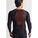 The Troy Lee Designs STAGE GHOST D30 LONG SLEEVE BASELAYER in black features red accents, ergonomic fit, chest and shoulder padding, zippered side, geometric pattern, underlayer protection system, and branded logos.