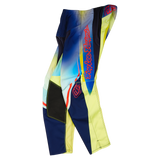 The Troy Lee Designs YOUTH GP PRO PANT DRIP in Glo Yellow/Dark Navy features blue, yellow, and black panels, red logo, geometric patterns, and reinforced durable sections, shown laid flat on a white background.