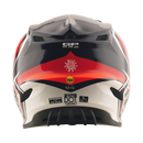 A Troy Lee Designs GP PRO HELMET CROSSOVER in navy and red, featuring bold graphics and the Mips brain protection system, is shown from the side with the brand name displayed on the visor.