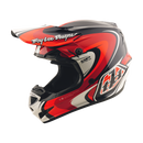 A Troy Lee Designs GP PRO HELMET CROSSOVER in navy and red, featuring bold graphics and the Mips brain protection system, is shown from the side with the brand name displayed on the visor.