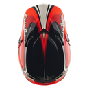 A Troy Lee Designs GP PRO HELMET CROSSOVER in navy and red, featuring bold graphics and the Mips brain protection system, is shown from the side with the brand name displayed on the visor.