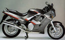 The Ventura EVO-12 Bike-Pack Kit for Triumph Trophy 1200 M,N,P,R (91-94) includes a black EVO-12 Pack, Evo-Rack Sport-Rack, and L-Bracket with screws; all are shown as generic images.