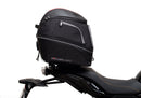 The Ventura EVO-12 Bike-Pack Kit for Yamaha Tracer 7 (23>) includes a black tail bag, EVO-RACK metal Sport-Rack, L-brackets with screws, all shown on a white background with product labels.