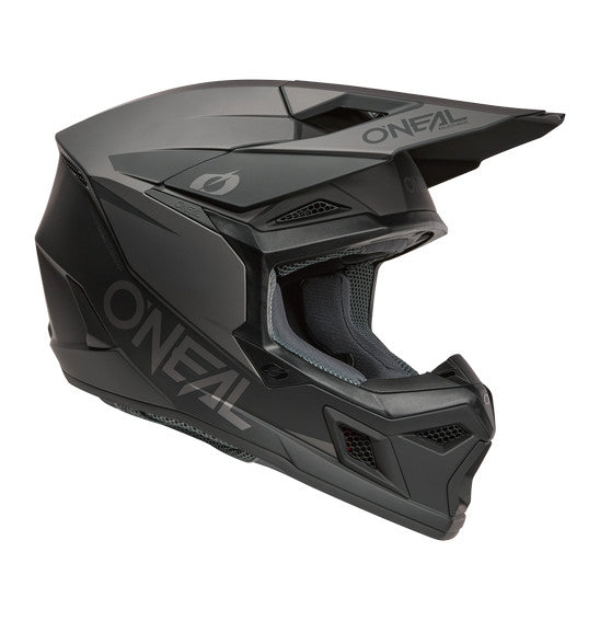 The O'Neal 2026 3SRS SOLID Helmet in black/grey by ONEAL offers full-face coverage, a visor, chin guard, and vent openings. Its angular ABS shell design features the ONEAL logo on the side and visor.
