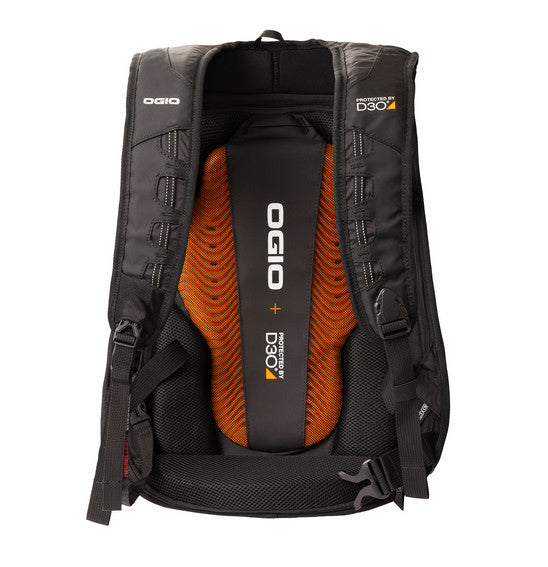 The Ogio MACH 5 D30 Motorcycle Backpack - Stealth is a sleek black backpack featuring a hard shell cover, designed specifically for street riders. It includes two white accent lines running vertically along the edges and prominently displays the OGIO logo in white. For added comfort and protection, the backpack has padded shoulder straps and advanced back support.