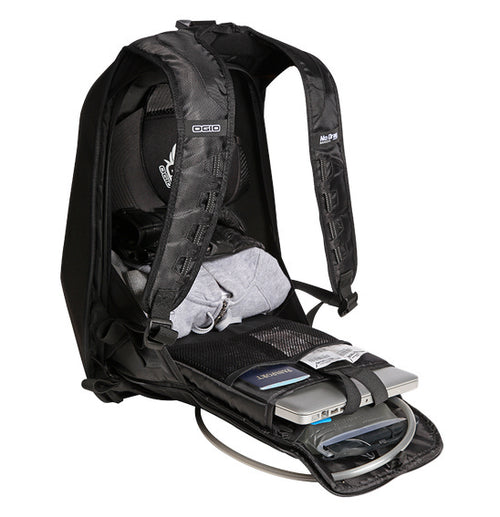 A black Ogio MACH 1 Motorcycle Backpack - Stealth with its front section unzipped and laid open, revealing multiple compartments and pockets inside, designed to securely carry laptops and other items. The "No Prgs" logo is visible on the interior. Featuring No Drag Technology, the padded straps provide comfort and enhance aerodynamic efficiency.