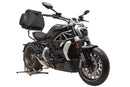 The image of the Ducati 1200 X Diavel (16-18) by Ventura features a cushioned black pack labeled 'EVO-12 PACK', an 'Adjustable Pack-Rack' mounted to a bike, an L-bracket labeled 'Generic Image', and bolts and washers, all set against a clean white background.