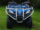 A Ventura CF Moto ATV X500EPS (2017) in blue with black wheels, sturdy bull-bars, and protective silver bars is parked on green grass, backed by dense green bushes.