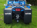 A Ventura CF Moto ATV X500EPS (2017) in blue with black wheels, sturdy bull-bars, and protective silver bars is parked on green grass, backed by dense green bushes.