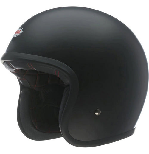 A side view of the Bell CUSTOM 500 Matte Black (NO Studs) motorcycle helmet highlights its smooth, rounded shape and minimalist design. This BELL helmet boasts a low-profile fit and features a small ventilation button near the bottom edge.