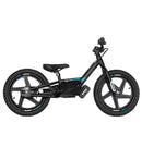The STACYC 16eDRIVE Brushless - Electric Balance Bike by STACYC is a black model equipped with 16” composite wheels and a high-output brushless motor. It features large tires, a low seat, and adjustable handlebars, highlighted in blue and white with brand markings on the frame. Its compact, minimalist design incorporates a lithium-ion battery.