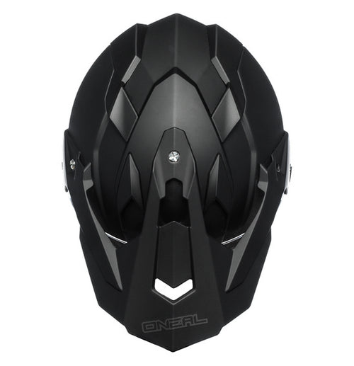 The O'Neal SIERRA Helmet R V.23 in flat black features a matte finish and angular, geometric design details on top; "ONEAL" branding is near the visor front, making it ideal for adventure bike riders.