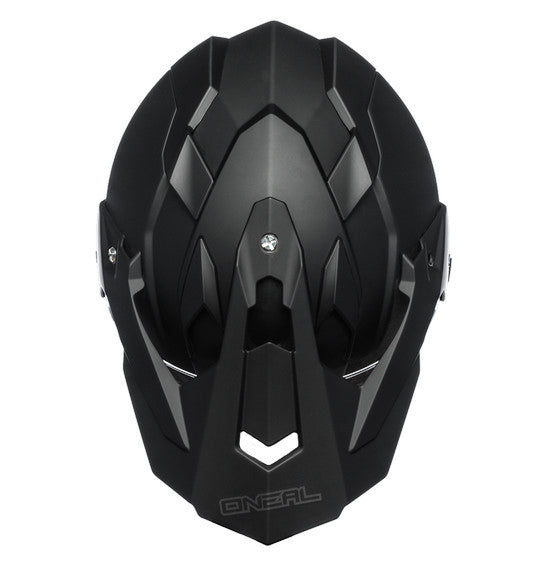 The O'Neal SIERRA Helmet R V.23 in flat black features a matte finish and angular, geometric design details on top; "ONEAL" branding is near the visor front, making it ideal for adventure bike riders.
