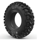 A black, rugged off-road tire known as the "BKT W207 - All Terrain Bias" from BKT. This tire boasts large, angular tread blocks crafted for superior traction on rough terrains and is enhanced by a deep tread design that provides additional grip. The white background accentuates the tire’s texture and highlights its puncture resistance features.