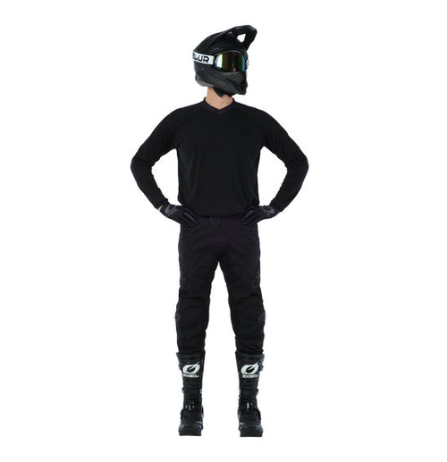 Person wearing a black motorcycle helmet, an O'Neal ELEMENT Classic Jersey - Black by ONEAL made from breathable moisture-wicking material, pants designed with durable wear-resistant panels, and boots. They stand with their hands on their hips, facing away from the camera against a white background.