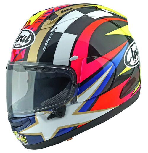 A side view of a colorful motorcycle helmet with intricate patterns in black, white, red, yellow, and blue. The Arai RX-7V EVO - Schwantz 30 prominently displays the number 74 and the ARAI brand logo on its side. This Kevin Schwantz Helmet features a clear visor and a sleek, aerodynamic design that meets ECE R22-06 standards.