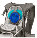 A close-up of the ONEAL O'NEAL Romer Hydration Backpack reveals a hydration bladder partially visible through an open zipper compartment. The blue hydration pack with a black cap is ideal for outdoor activities, boasting padded straps, mesh pockets, and adjustable chest and waist straps.