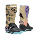 The FOX 180 HELLO FUTURE BOOTS from FOX feature beige, black, and pastel accents, a high-top design with multiple buckles, bold branding, a purple logo, and "HELLO FUTURE" on the strap—rugged durability meets future style.