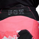 The FOX 180 DIGI IMAGE PANTS feature a pink, black, and white geometric camo design, black knee panels, and a FOX logo on the thigh—built for dirt bike riders seeking comfort and mobility in the Rider Attack Position. Displayed on a white background.