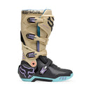 The FOX 180 HELLO FUTURE BOOTS from FOX feature beige, black, and pastel accents, a high-top design with multiple buckles, bold branding, a purple logo, and "HELLO FUTURE" on the strap—rugged durability meets future style.