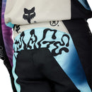 FOX 180 HELLO FUTURE PANTS by FOX feature black fabric with white, blue, and pink accents, bold logos, graphic designs on the thighs and waistband, plus reinforced knees. These motocross pants are shown on a white background.