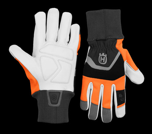 The Husqvarna Functional Gloves with saw protection, by Husqvarna, combine gray, white, black, and orange coloring. The left glove is displayed palm-up while the right glove is displayed palm-down. Both gloves feature a prominent gray logo on the wrist area and have ribbed cuffs for a secure fit.