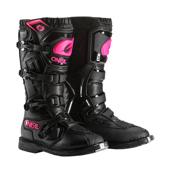 The O'Neal Women's RIDER PRO Boot in Black/Pink features the brand name "ONEAL" prominently and boasts multiple buckles along with rugged soles that have "ONEAL" embossed on the bottom. One boot stands upright while the other is tilted to display the sole, making them perfect for any motocross enthusiast.