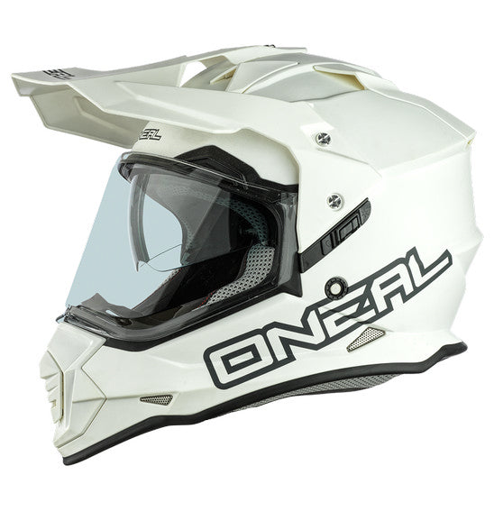 The front view of the O'Neal SIERRA Helmet R V.23 in Flat White showcases its angular design and geometric patterns. Designed by ONEAL, this stylish helmet is perfect for adventure bikes, featuring an integrated face shield, a small visor, and prominent branding—ideal for both safety and style.