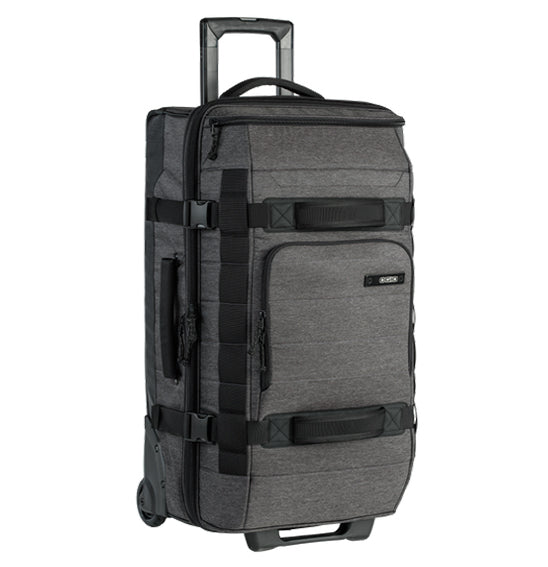The OGIO ONU 26 Travel Bag in Dark Static features a retractable handle extended, multiple handles on the front and side, black straps for additional support, and several compartments. The OGIO logo is visible near the top. Its rugged TPU wheel set allows it to stand upright on its wheels.