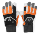 The Husqvarna Functional Gloves with saw protection, by Husqvarna, combine gray, white, black, and orange coloring. The left glove is displayed palm-up while the right glove is displayed palm-down. Both gloves feature a prominent gray logo on the wrist area and have ribbed cuffs for a secure fit.