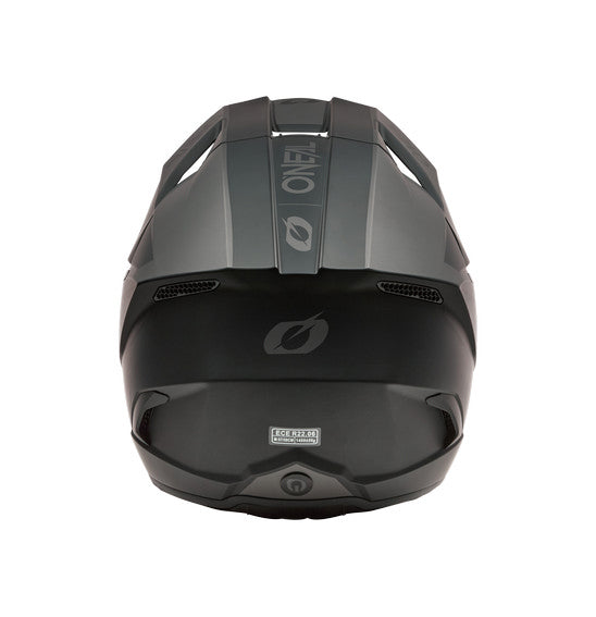 The O'Neal 2026 3SRS SOLID Helmet in black/grey by ONEAL offers full-face coverage, a visor, chin guard, and vent openings. Its angular ABS shell design features the ONEAL logo on the side and visor.