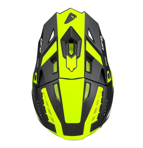 The UFO Echus Helmet in neon yellow and black features angular geometric designs, an alien logo near the back, and "UFO" branding. ECE 22.06 certified, it ensures top-notch safety for off-road adventures with its visor-equipped design.