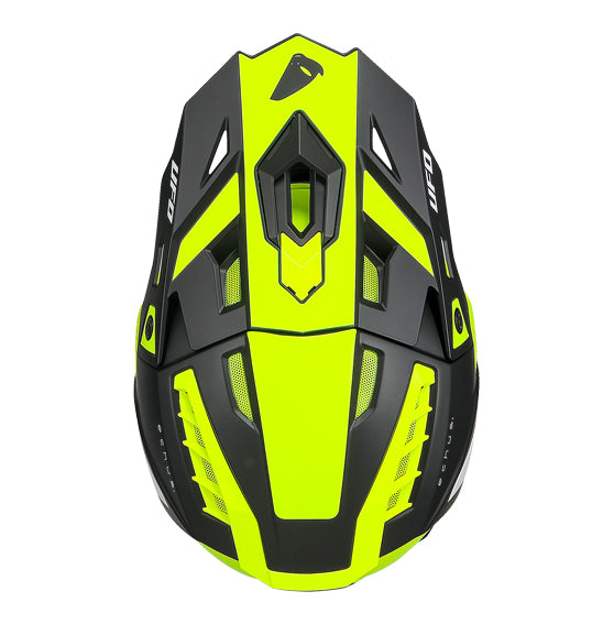 The UFO Echus Helmet in neon yellow and black features angular geometric designs, an alien logo near the back, and "UFO" branding. ECE 22.06 certified, it ensures top-notch safety for off-road adventures with its visor-equipped design.
