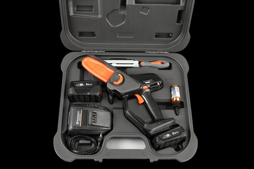 The Husqvarna Aspire™ Pruner Case is a black, hard plastic carrying case adorned with the Husqvarna logo and "ASPIRE" printed in white on the front. Reminiscent of rugged motorbike gear, it includes an ergonomic handle and an orange latch on top, with "PRUNER" embossed at the bottom.