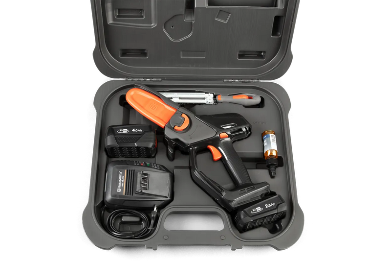 The Husqvarna Aspire™ Pruner Case is a black, hard plastic carrying case adorned with the Husqvarna logo and "ASPIRE" printed in white on the front. Reminiscent of rugged motorbike gear, it includes an ergonomic handle and an orange latch on top, with "PRUNER" embossed at the bottom.