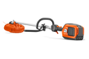 Image of a Husqvarna 325iRJ Brushcutter (skin) ideal for maintaining lawns. The tool features a long handle with a circular black grip near the middle, a power unit at one end, and a trim head with a protective orange cover at the other end. The trimmer is laid on a white background.