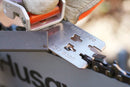 Two identical Husqvarna File Guides are shown side by side. One is silver, while the other is gold. Each guide has two rollers secured within a sturdy, angular frame reminiscent of filing angles used with Husqvarna chains. The objects are placed on a white background.