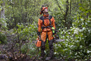 Displayed is the "Husqvarna Extreme Forest Jacket," an orange and black outdoor jacket with gray accents and reflective strips. It features a high collar, long sleeves, ventilation openings for added comfort, and zippered pockets. The brand name "Husqvarna" is visible on the chest.