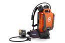 A black Husqvarna Battery Adapter with an LCD display and a connected power cord, ideal for outdoor use. The adapter's robust, compact design ensures efficient battery charging for various Husqvarna tools, perfect for maintaining gardens and lawns. The power cord features a connector at the end.