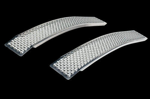 Two curved Husqvarna Curved Loading Ramps in a sleek silver finish are made of durable sea water-resistant aluminum and feature tiny, glittering bead-like embellishments. The ramps are displayed side by side on a white background, with the beads adding a textured, sparkling effect.