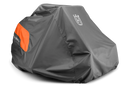 A large orange lawnmower, partially covered by a Husqvarna Zero Turn Mower Cover from Husqvarna, made of water-resistant material and featuring an "H" logo. The mower has four wheels and sleek design elements. The heavy-duty cover reveals part of the mower's body and wheels.