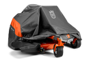 A large orange lawnmower, partially covered by a Husqvarna Zero Turn Mower Cover from Husqvarna, made of water-resistant material and featuring an "H" logo. The mower has four wheels and sleek design elements. The heavy-duty cover reveals part of the mower's body and wheels.
