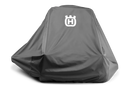 A large orange lawnmower, partially covered by a Husqvarna Zero Turn Mower Cover from Husqvarna, made of water-resistant material and featuring an "H" logo. The mower has four wheels and sleek design elements. The heavy-duty cover reveals part of the mower's body and wheels.