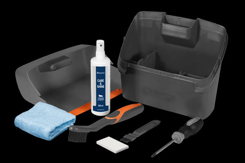 Introducing the Husqvarna Automower Cleaning and Maintenance Kit: This all-inclusive set comes complete with a plastic container, grey dustpan, blue cloth, cleaning spray bottle, handheld brush, small white block, scraper tool, and screwdriver. Perfect for maintaining your Husqvarna automower with ease and keeping it in top condition.