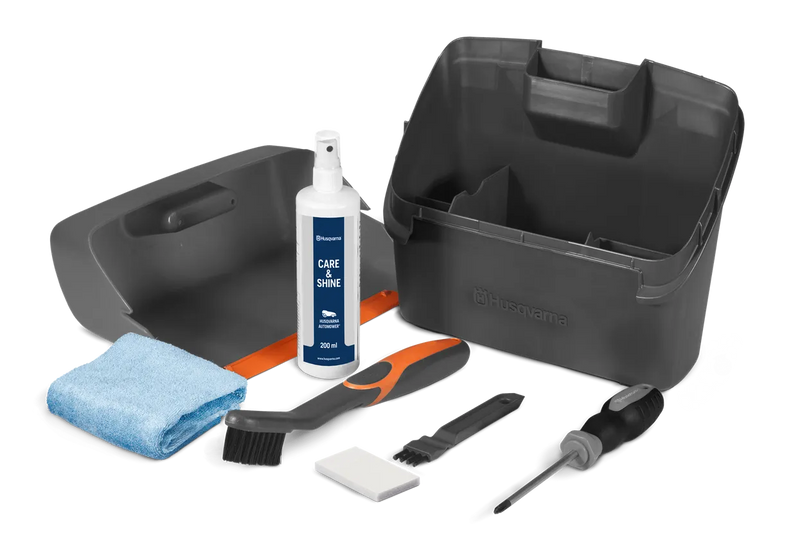 Introducing the Husqvarna Automower Cleaning and Maintenance Kit: This all-inclusive set comes complete with a plastic container, grey dustpan, blue cloth, cleaning spray bottle, handheld brush, small white block, scraper tool, and screwdriver. Perfect for maintaining your Husqvarna automower with ease and keeping it in top condition.