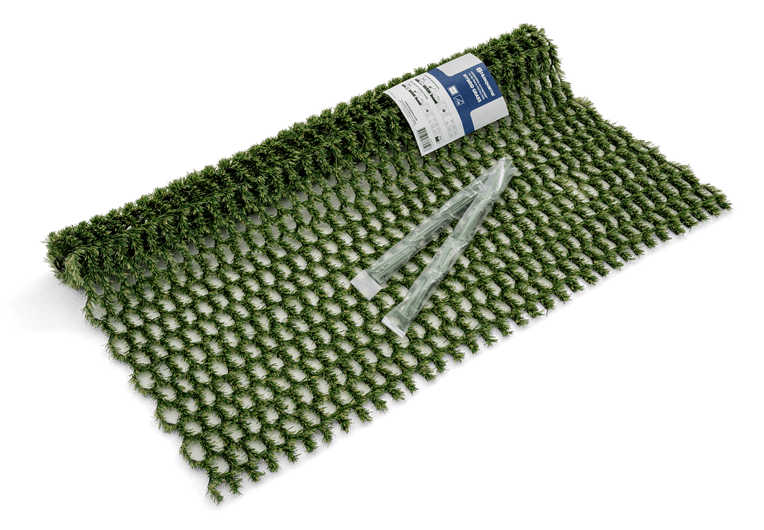 A pack of Husqvarna Automower® Hybrid Grass kit is displayed on a mesh surface. The kit includes green synthetic grass pegs and a package that reads "Husqvarna Automower® Hybrid Grass" and "11 X Extra Protection." Perfect accessories for your Husqvarna robotic lawn mower.