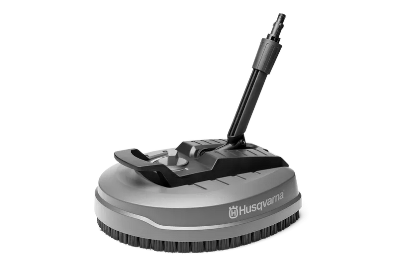 The image shows a Husqvarna Surface Cleaner SC 400 attachment designed for pressure washers. It has a round base with bristles on the underside and a swivel handle attachment on top. The rotating cleaner also features the Husqvarna logo visibly displayed on the side.