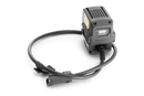 A black Husqvarna Battery Adapter with an LCD display and a connected power cord, ideal for outdoor use. The adapter's robust, compact design ensures efficient battery charging for various Husqvarna tools, perfect for maintaining gardens and lawns. The power cord features a connector at the end.